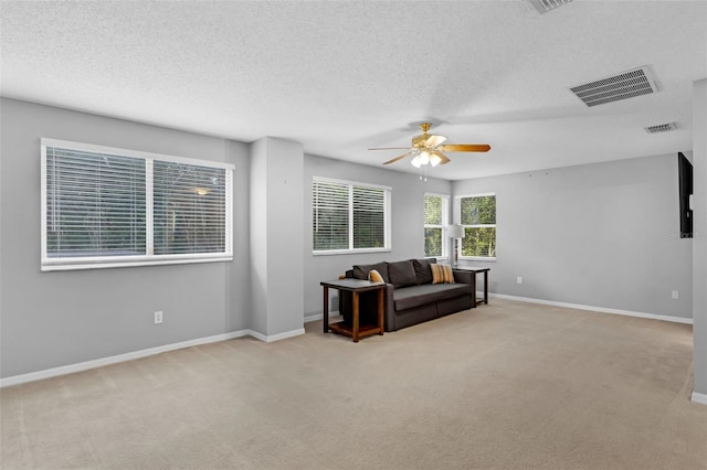 1245 Reagans Reserve Blvd, Apopka, FL 32712 - carpeted living room with a ceiling fan, baseboards, and a textured ceiling