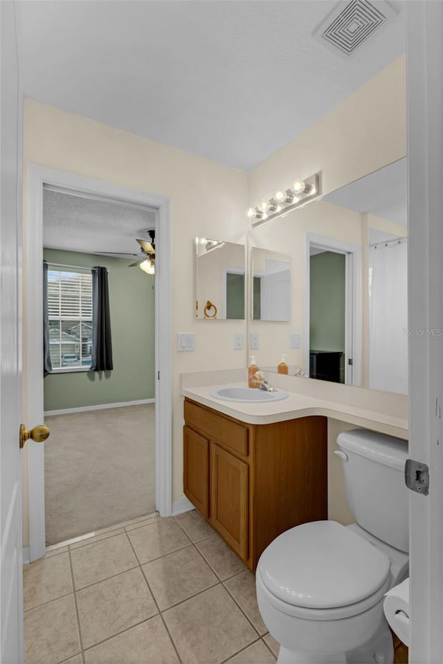 1245 Reagans Reserve Blvd, Apopka, FL 32712 - full bathroom featuring vanity, toilet, a ceiling fan, tile patterned floors, and baseboards