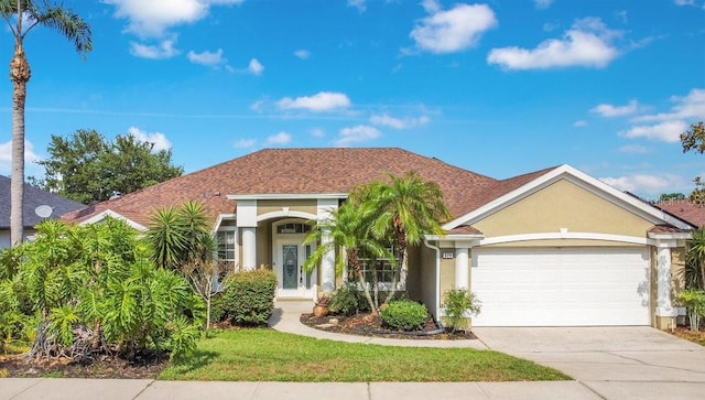 529 Quail Down Dr, Debary, FL 32713 - view of front of home with stucco siding, an attached garage, driveway, and roof with shingles