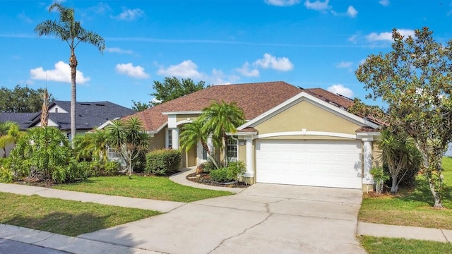 529 Quail Down Dr, Debary, FL 32713 - view of front facade with stucco siding, an attached garage, concrete driveway, and a front yard