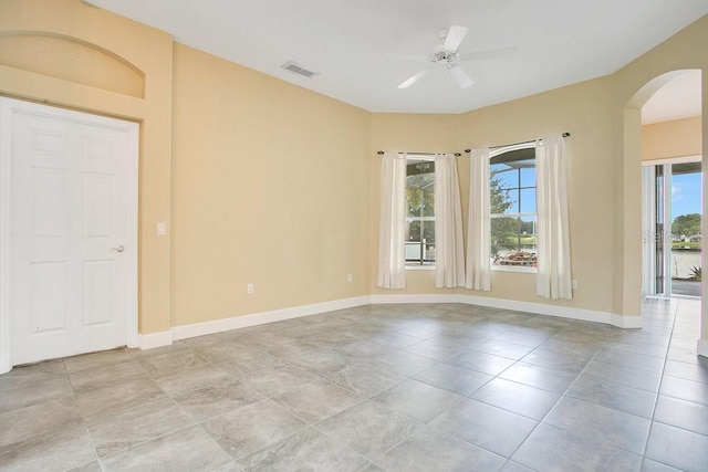529 Quail Down Dr, Debary, FL 32713 - spare room featuring arched walkways, healthy amount of natural light, ceiling fan, and baseboards