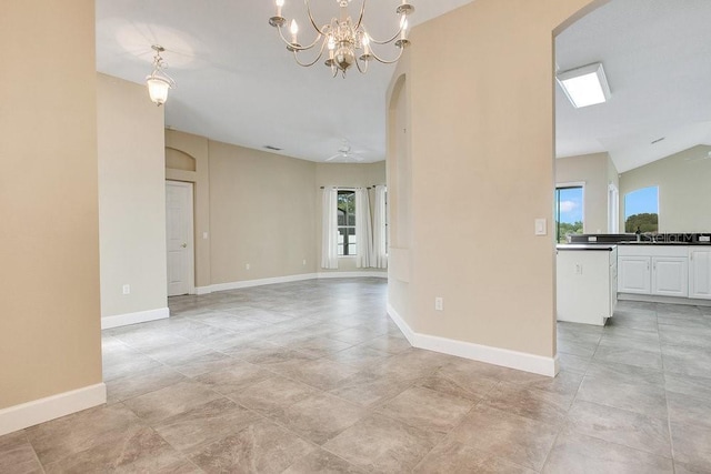 529 Quail Down Dr, Debary, FL 32713 - spare room featuring arched walkways, a chandelier, baseboards, and a sink
