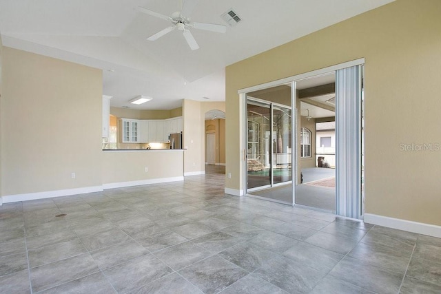 529 Quail Down Dr, Debary, FL 32713 - empty room with ceiling fan, arched walkways, lofted ceiling, and baseboards