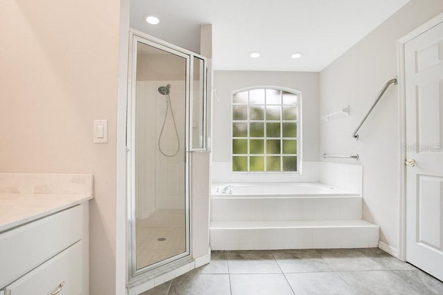 529 Quail Down Dr, Debary, FL 32713 - bathroom with a garden tub, a stall shower, tile patterned floors, vanity, and recessed lighting