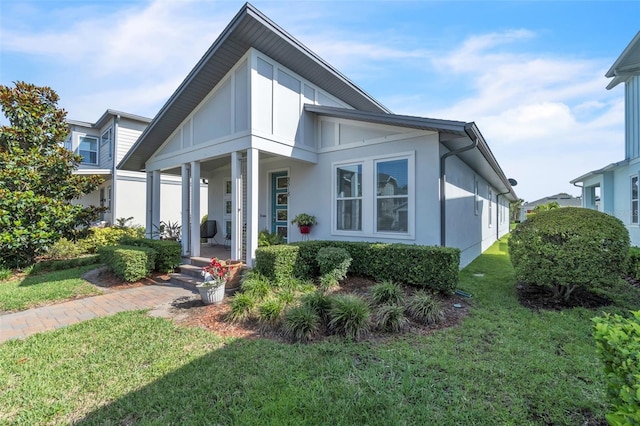 8518 Nemours Pkwy, Orlando, FL 32827 - view of front of home featuring a porch, a front lawn, and stucco siding