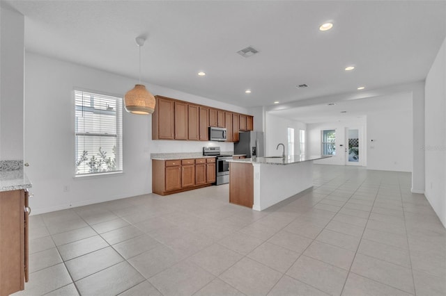 8518 Nemours Pkwy, Orlando, FL 32827 - kitchen with stainless steel appliances, a sink, open floor plan, plenty of natural light, and recessed lighting