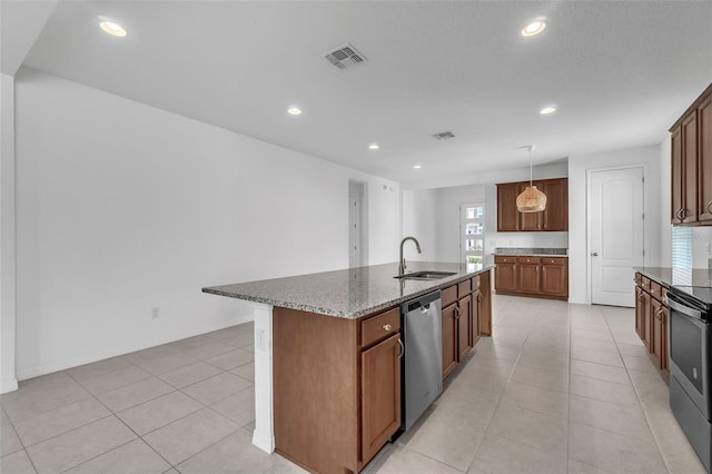 8518 Nemours Pkwy, Orlando, FL 32827 - kitchen featuring a sink, appliances with stainless steel finishes, stone countertops, light tile patterned floors, and recessed lighting