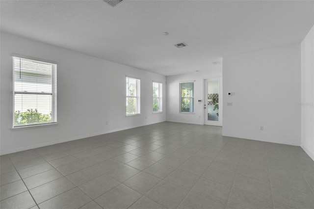 8518 Nemours Pkwy, Orlando, FL 32827 - spare room featuring baseboards and tile patterned flooring
