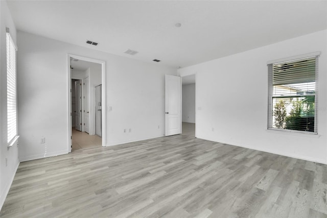 8518 Nemours Pkwy, Orlando, FL 32827 - empty room featuring plenty of natural light, light wood finished floors, and baseboards