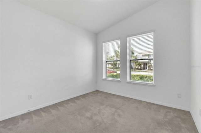 8518 Nemours Pkwy, Orlando, FL 32827 - unfurnished room featuring vaulted ceiling, light carpet, and baseboards