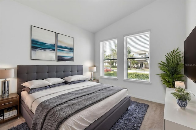 8518 Nemours Pkwy, Orlando, FL 32827 - carpeted bedroom featuring vaulted ceiling and baseboards
