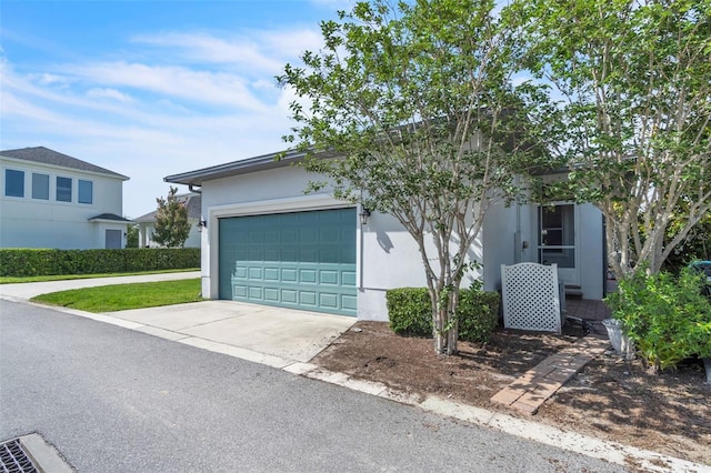 8518 Nemours Pkwy, Orlando, FL 32827 - view of front of house featuring stucco siding, an attached garage, and driveway
