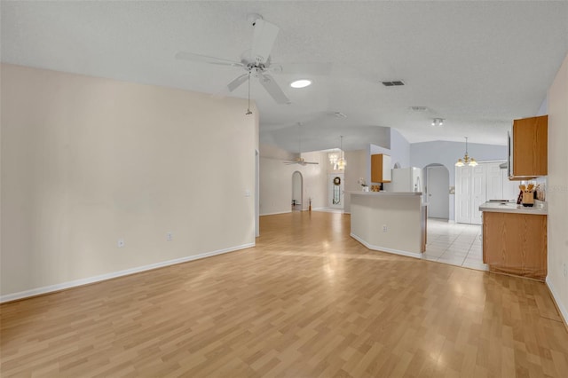 1181 Welch Hill Cir, Apopka, FL 32712 - unfurnished living room featuring arched walkways, vaulted ceiling, a ceiling fan, light wood-type flooring, and baseboards