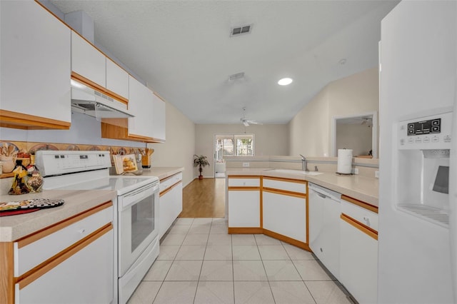 1181 Welch Hill Cir, Apopka, FL 32712 - kitchen featuring white appliances, a sink, a peninsula, under cabinet range hood, and white cabinetry