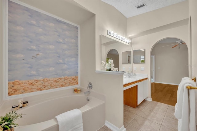 1181 Welch Hill Cir, Apopka, FL 32712 - full bath featuring vanity, a bath, tile patterned flooring, ceiling fan, and a textured ceiling