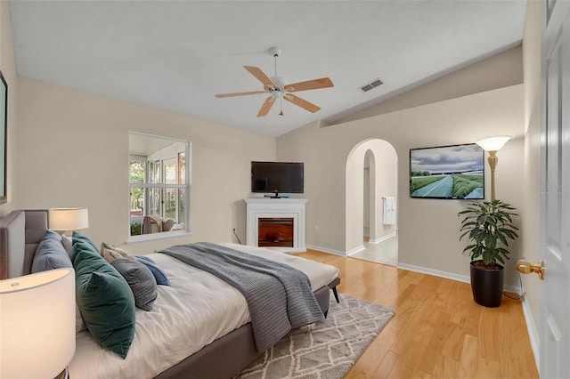 1181 Welch Hill Cir, Apopka, FL 32712 - bedroom featuring vaulted ceiling, arched walkways, light wood-style floors, baseboards, and ceiling fan