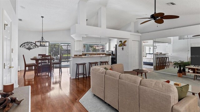 260 Coronado Dr, Punta Gorda, FL 33950 - living area featuring a ceiling fan, high vaulted ceiling, dark wood-type flooring, and baseboards