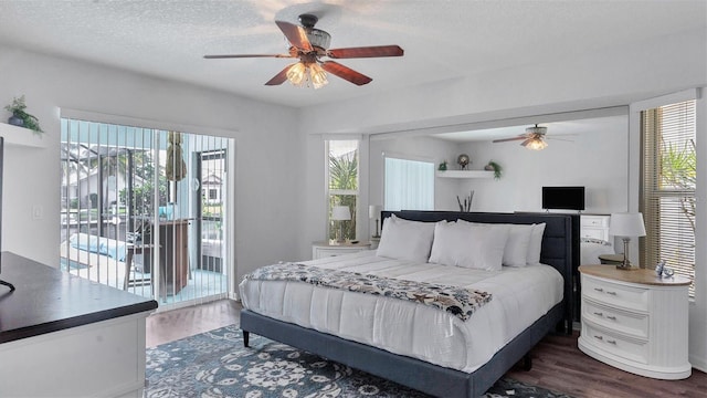 260 Coronado Dr, Punta Gorda, FL 33950 - bedroom featuring access to exterior, dark wood-type flooring, multiple windows, a textured ceiling, and a ceiling fan
