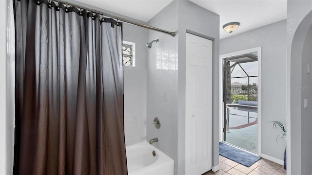 260 Coronado Dr, Punta Gorda, FL 33950 - full bathroom featuring shower / bath combo with shower curtain, tile patterned floors, and baseboards