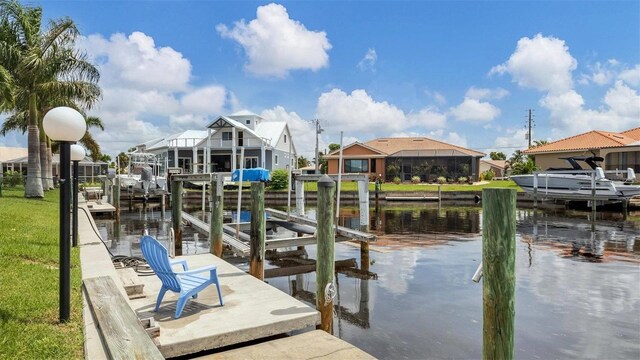 260 Coronado Dr, Punta Gorda, FL 33950 - dock with boat lift, a water view, and a residential view