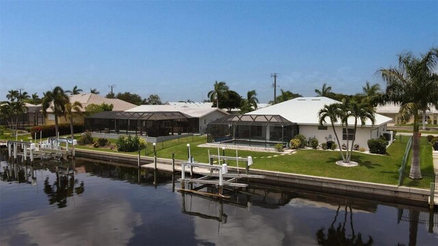 260 Coronado Dr, Punta Gorda, FL 33950 - dock with boat lift, a water view, glass enclosure, and a lawn