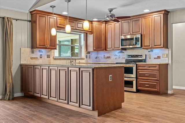3942 Orange Lake Dr, Orlando, FL 32817 - kitchen featuring appliances with stainless steel finishes, wood finished floors, ceiling fan, baseboards, and tasteful backsplash