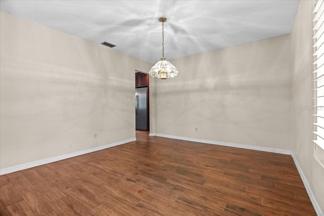 3942 Orange Lake Dr, Orlando, FL 32817 - empty room with a chandelier, dark wood-style floors, and baseboards