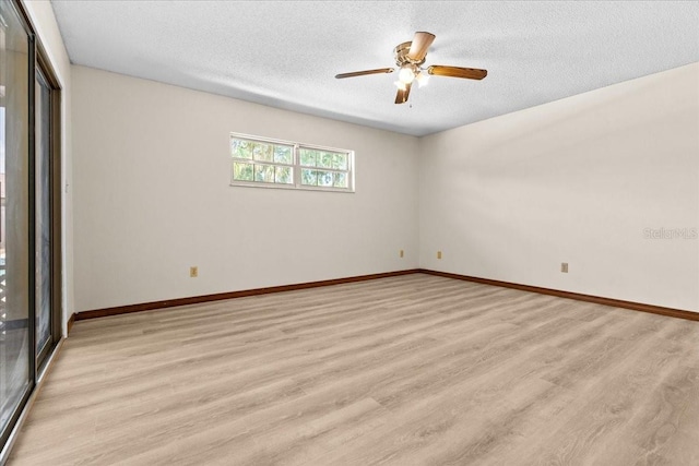 3942 Orange Lake Dr, Orlando, FL 32817 - empty room with light wood-style floors, a textured ceiling, baseboards, and a ceiling fan