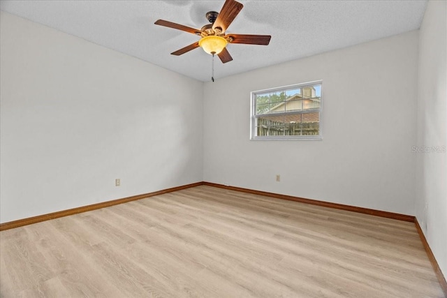 3942 Orange Lake Dr, Orlando, FL 32817 - empty room featuring light wood-type flooring, baseboards, ceiling fan, and a textured ceiling