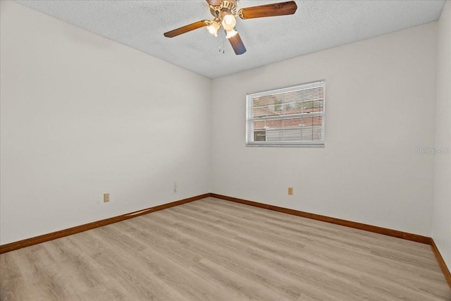 3942 Orange Lake Dr, Orlando, FL 32817 - empty room with light wood finished floors, a textured ceiling, baseboards, and ceiling fan