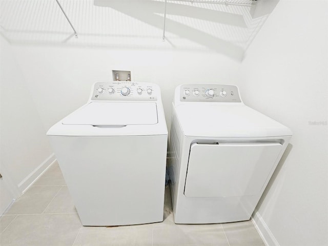 949 Leader St, Davenport, FL 33896 - laundry room featuring washer and dryer, light tile patterned floors, and baseboards