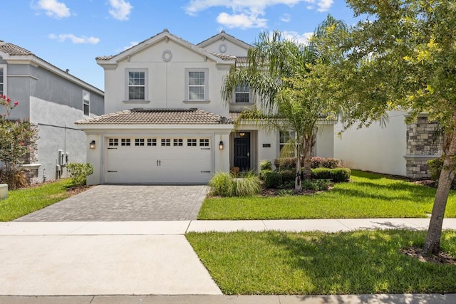 8822 Interlocking Ct, Davenport, FL 33896 - view of front facade with stucco siding, a tiled roof, driveway, a garage, and a front lawn