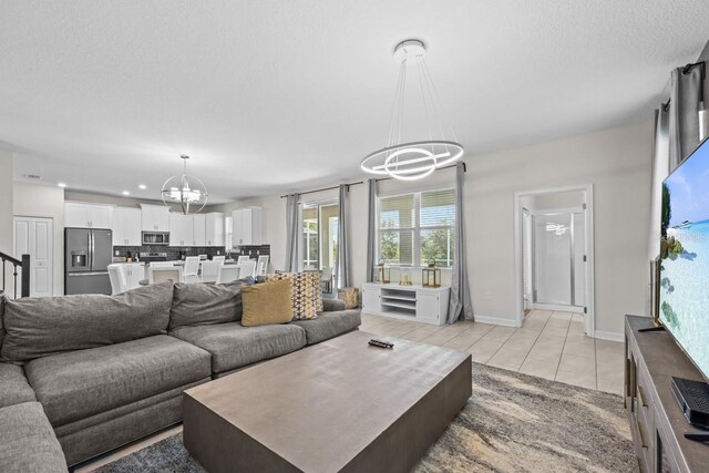 8822 Interlocking Ct, Davenport, FL 33896 - living area featuring a chandelier, light tile patterned flooring, recessed lighting, baseboards, and a textured ceiling