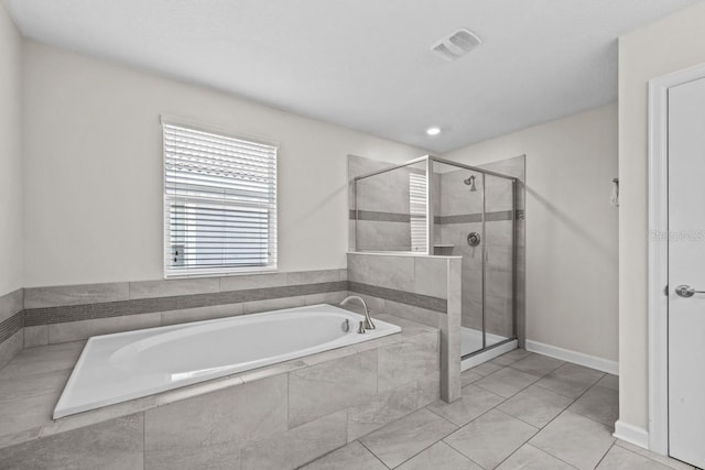 8822 Interlocking Ct, Davenport, FL 33896 - bathroom featuring a bath, a stall shower, and baseboards