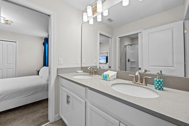 8822 Interlocking Ct, Davenport, FL 33896 - full bathroom with double vanity, connected bathroom, and an enclosed shower