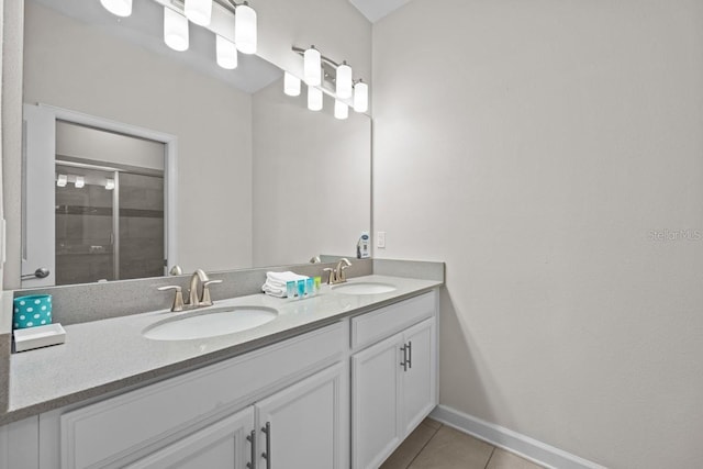 8822 Interlocking Ct, Davenport, FL 33896 - full bath with double vanity, tile patterned flooring, a shower stall, and baseboards