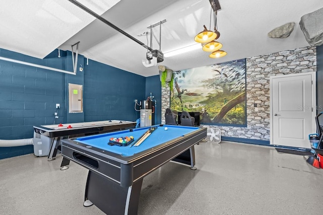 8822 Interlocking Ct, Davenport, FL 33896 - game room with electric panel, billiards, speckle patterned floor, water heater, and concrete block wall