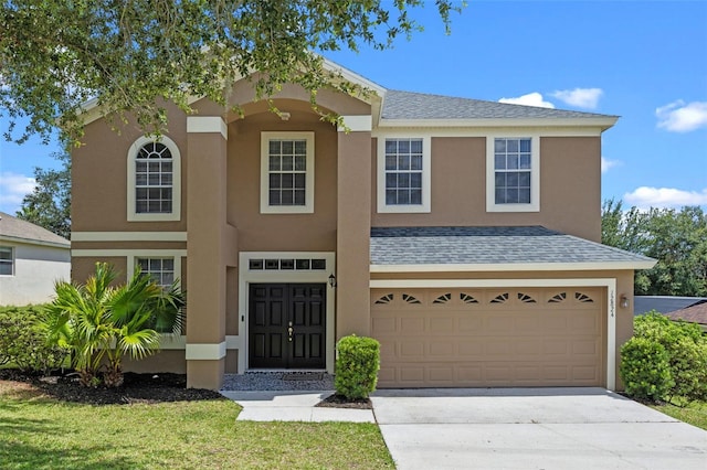 12824 Cloverdale Ln, Clermont, FL 34711 - view of front of home featuring concrete driveway, stucco siding, a garage, and a shingled roof
