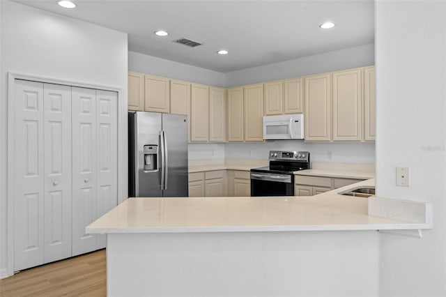12824 Cloverdale Ln, Clermont, FL 34711 - kitchen featuring stainless steel fridge with ice dispenser, white microwave, electric stove, cream cabinets, and recessed lighting