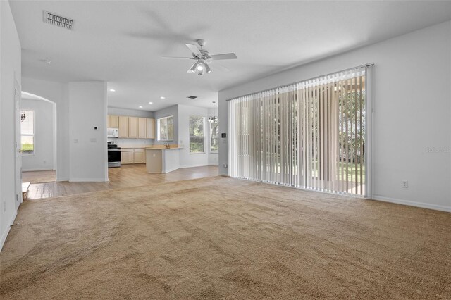 12824 Cloverdale Ln, Clermont, FL 34711 - unfurnished living room with light carpet, ceiling fan, and recessed lighting
