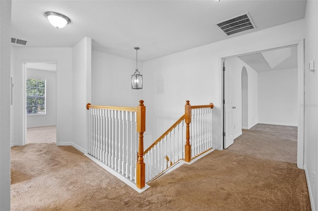 12824 Cloverdale Ln, Clermont, FL 34711 - corridor with an upstairs landing, carpet, and arched walkways
