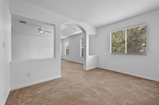 12824 Cloverdale Ln, Clermont, FL 34711 - carpeted spare room with arched walkways, healthy amount of natural light, and a ceiling fan