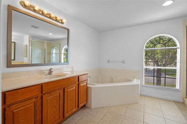 12824 Cloverdale Ln, Clermont, FL 34711 - full bathroom featuring vanity, a bath, tile patterned flooring, and a stall shower