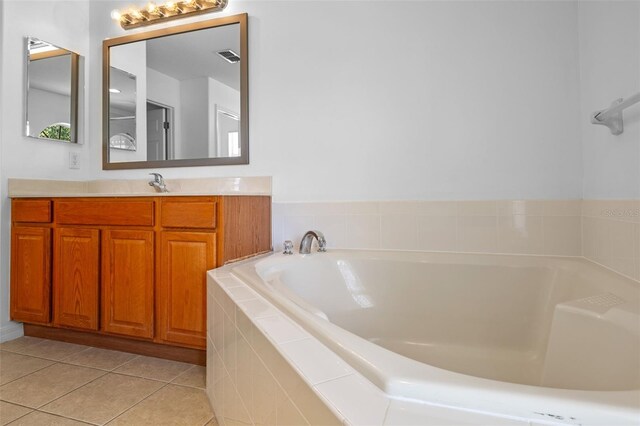 12824 Cloverdale Ln, Clermont, FL 34711 - bathroom featuring vanity, a garden tub, and tile patterned flooring