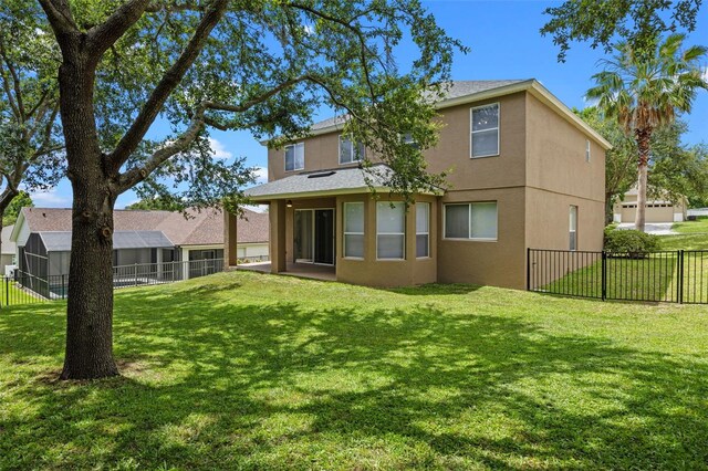 12824 Cloverdale Ln, Clermont, FL 34711 - rear view of house with stucco siding and a fenced backyard