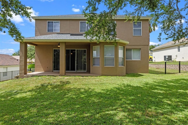 12824 Cloverdale Ln, Clermont, FL 34711 - rear view of house with stucco siding, a patio, and a fenced backyard