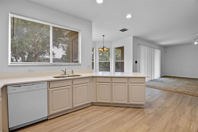 12824 Cloverdale Ln, Clermont, FL 34711 - kitchen with white dishwasher, light wood-style flooring, light countertops, a chandelier, and recessed lighting