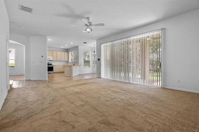 12824 Cloverdale Ln, Clermont, FL 34711 - unfurnished living room with light carpet, ceiling fan, and recessed lighting