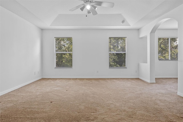 12824 Cloverdale Ln, Clermont, FL 34711 - spare room with a tray ceiling, arched walkways, carpet, and plenty of natural light