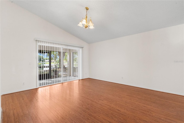 9145 Fort Jefferson Blvd, Orlando, FL 32822 - unfurnished room with a chandelier, wood finished floors, baseboards, and high vaulted ceiling